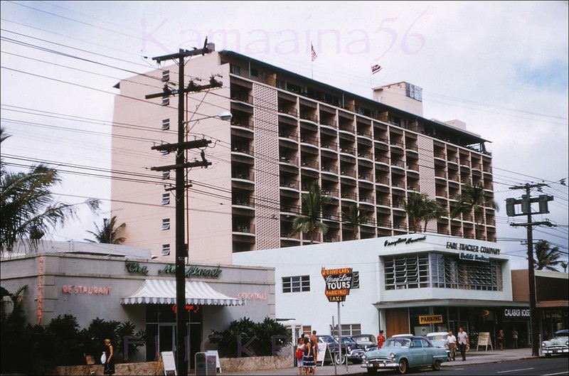 Mauka view from in front of the Surfrider wing of the Moana hotel of Waikiki’s Kalakaua Avenue just diamond head of Kaiulani Avenue, 1956.
