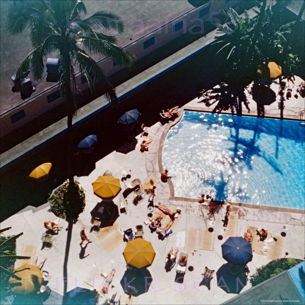 Looking down from an upper floor at the pool court of the Waikiki Biltmore Hotel, 1956