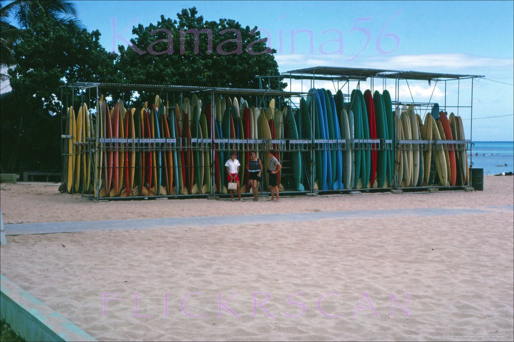 Rental surfboard racks at the Waikiki Beach Center seen from Kalakaua Avenue, 1963