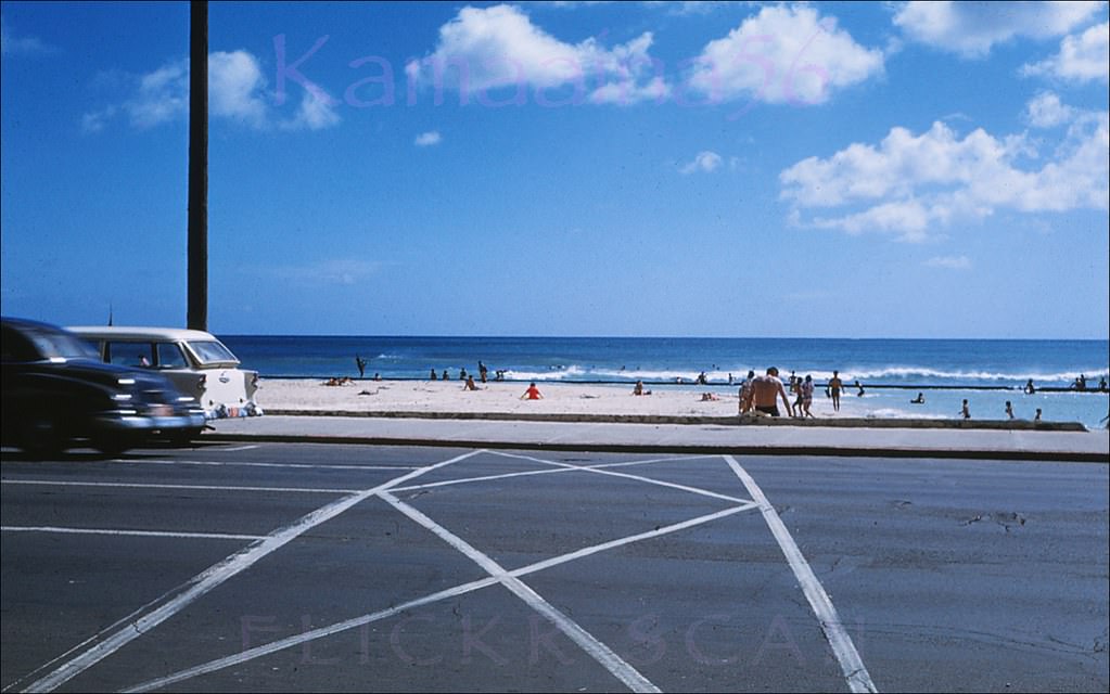 Mid-afternoon sun at the Kuhio Breakwater viewed from the Kealohilani and Kalakaua intersection in Waikiki, 1960