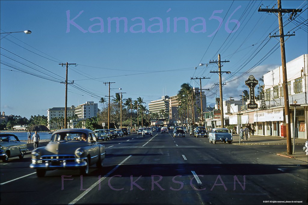 Late afternoon westerly view along Waikiki’s Kalakaua Avenue from Paoakalani Avenue, 1956