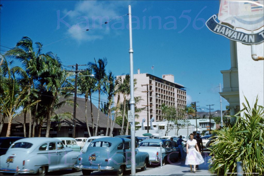 Street scene looking east along Kalakaua Avenue from the driveway at the Outrigger Canoe club next to the Moana Hotel, 1955