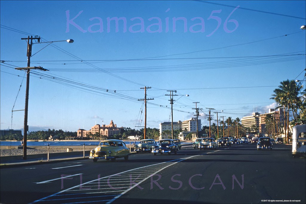 Late afternoon ewa view along Waikiki’s Kalakaua Avenue at the Kapahulu Avenue intersection, 1956
