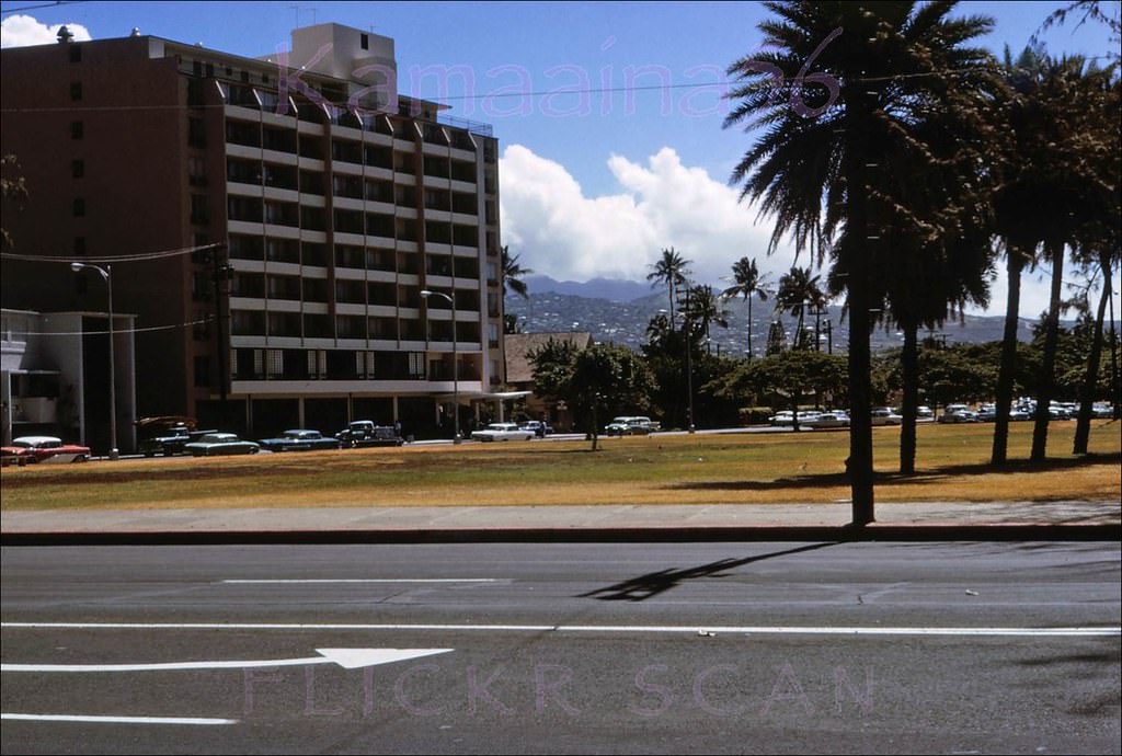 Looking Mauka across Kalakaua Avenue towards the Waikiki Grand Hotel on Kapahulu Avenue facing the Waikiki Zoo, 1964