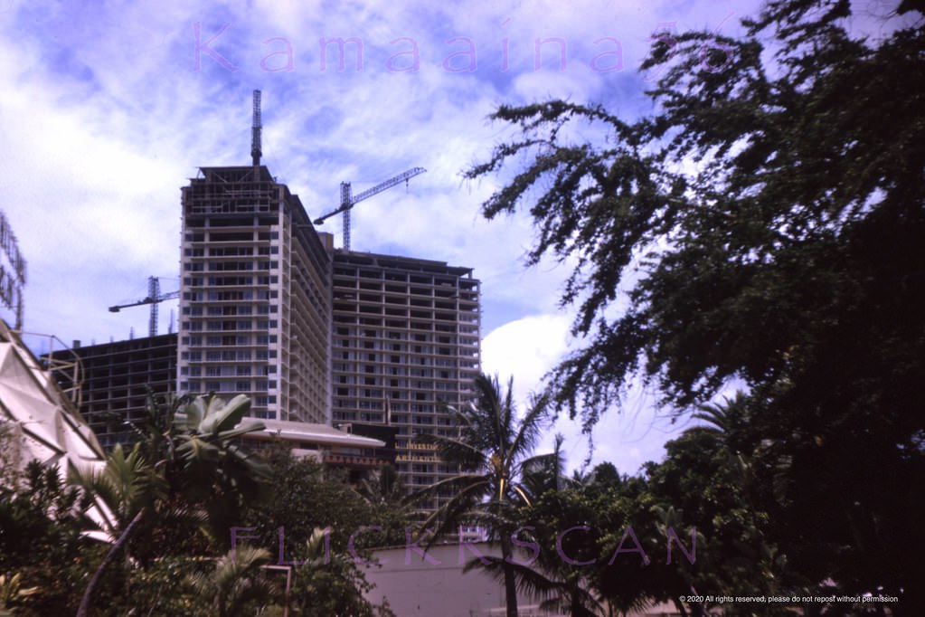 Waikiki’s landmark 26 floor Ilikai Hotel under construction viewed from the neighboring Hilton Hawaiian Village Hotel looking makai (towards the ocean), 1963