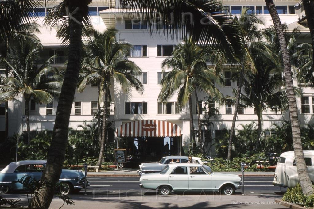 The porte-cochere entrance to the stately Moana Hotel seen from across Kalakaua Avenue, 1962