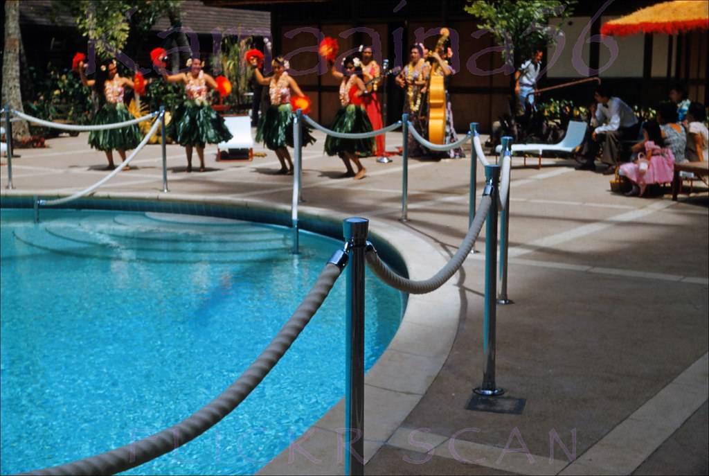 Hula dancers with uli-uli at the Princess Kaiulani Hotel pool court, 1955