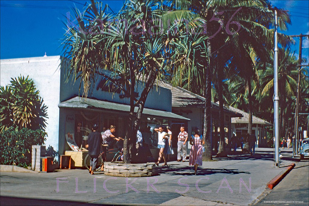 Looking west along Waikiki’s Kalakaua Avenue at the Outrigger Arcade shops seen from the next door Moana Hotel, 1955