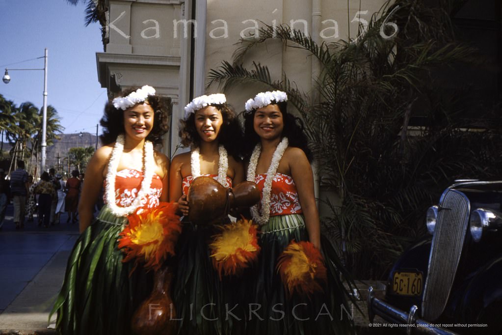 A trio of pretty hula girls posing for a souvenir photo in the Moana Hotel's porte-cochère on Waikiki’s Kalakaua Avenue, 1952