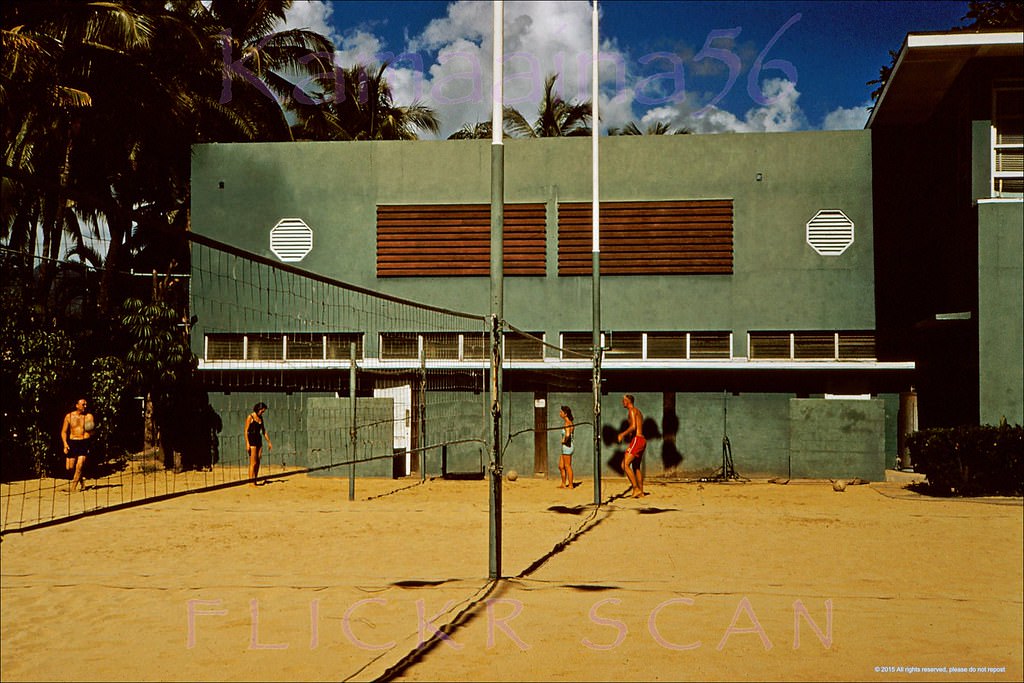 The Outrigger Canoe Club's volleyball court viewed from the beach clubhouse looking mauka, 1958