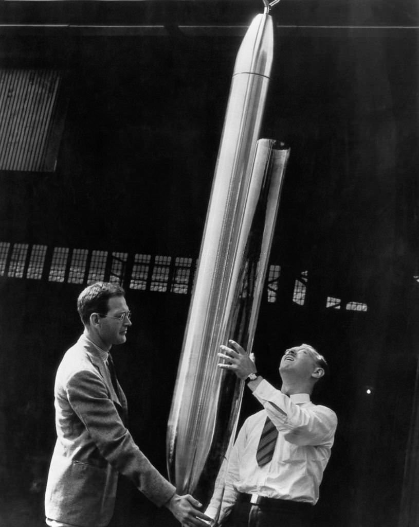 The first Westinghouse Time Capsule, a 7.5 foot capsule with an inner shell of heat-resistant glass, is inspected by two experts before being shipped to the 1939 New York World's Fair.