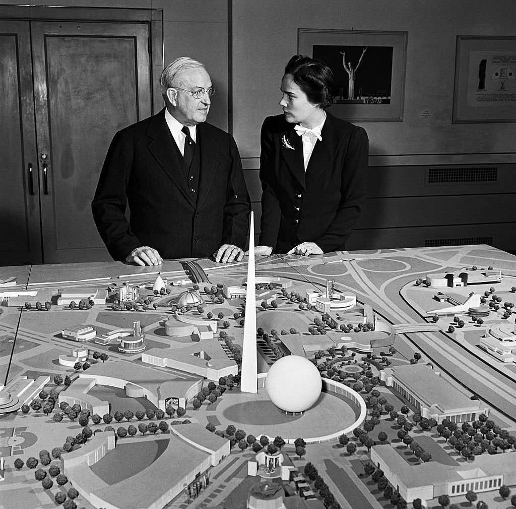 A man and woman stand in front of a model of the site of the 1939 New York World's Fair in Flushing Meadows, Queens in the summer of 1938 in New York City.