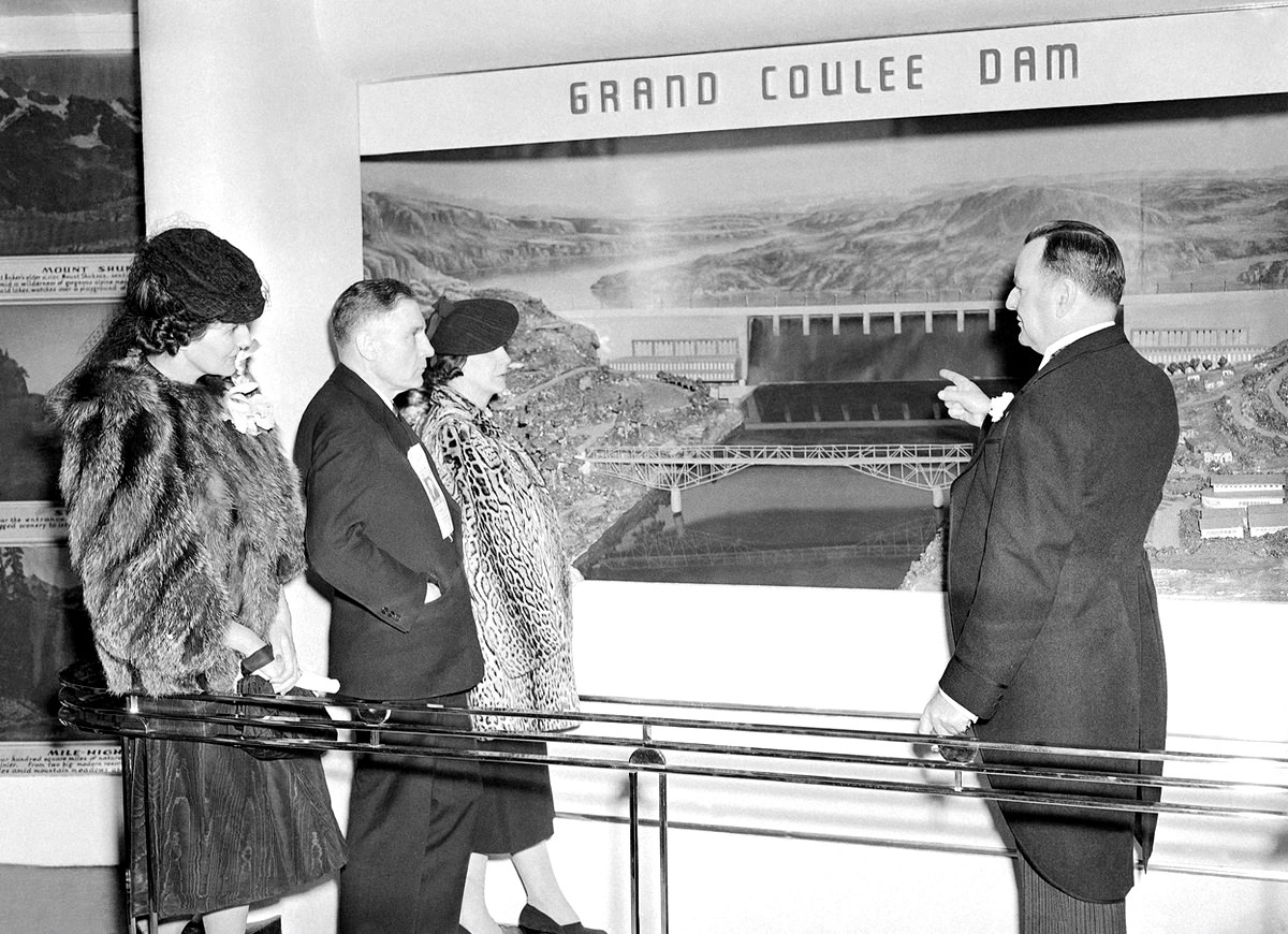 Prominent representatives of the state of Washington look at a diorama of Grand Coulee dam, part of their state's exhibit at the New York World's Fair on May 1, 1939,