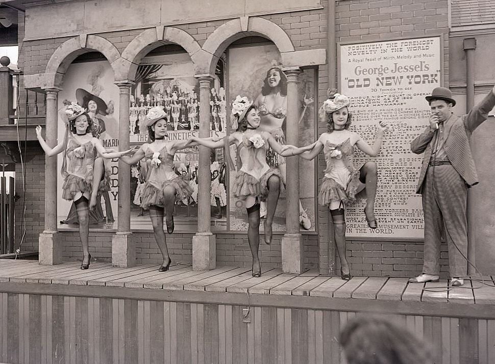 A barker performs with show girls at George Jessel's "old New York" cabaret, at the New York World's Fair, 1939