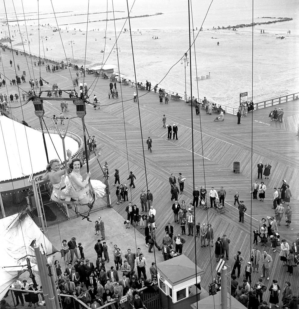 Models from the CBS gameshow, "The Big Payoff," Connie Mavis and Pat Conway ride The Parachute Jump, originally built for the 1939 World's Fair, at Steeplechase Park.