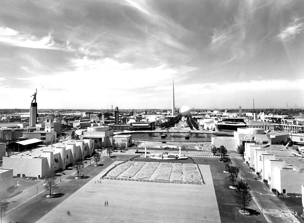 Overall view of the fairgrounds at the New York World's Fair of 1939, New York. The USSR building's statue of a worker is visible on the left, and the Trylon and Perisphere are visible in the center background.