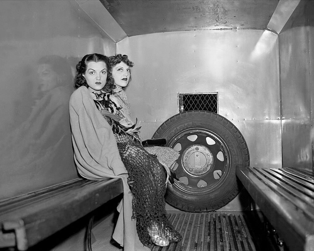 Two dancers at the 1939 World's Fair, Dolores Irwin (left) and Marge Berk, sit in a patrol wagon after their arrest on the night of May 31, 1939-