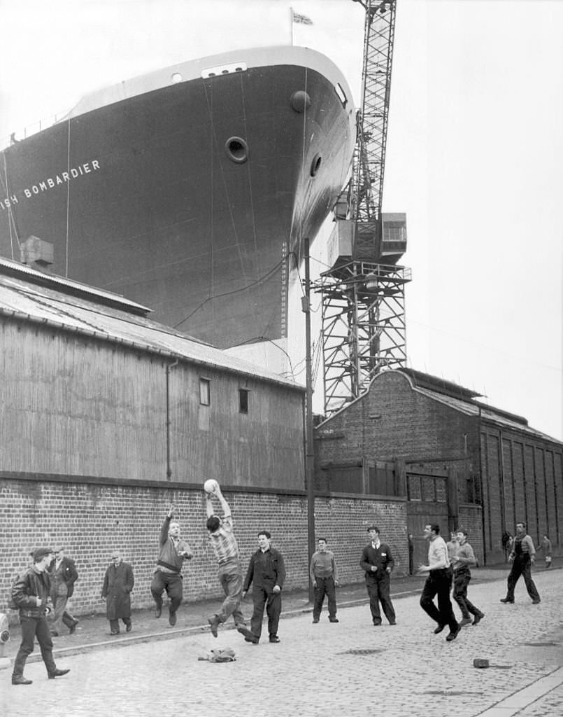 The British Bombadier Cargo ship towering over the surrounding warehouses at Clyde Dockyard, Glasgow, 1962