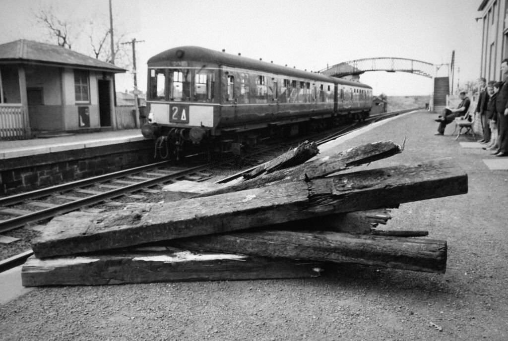 A train passes Kennishead station, in the foreground the scraps of timber which have been laid on the tracks for sabotage, in Glasgow, April 26, 1965.