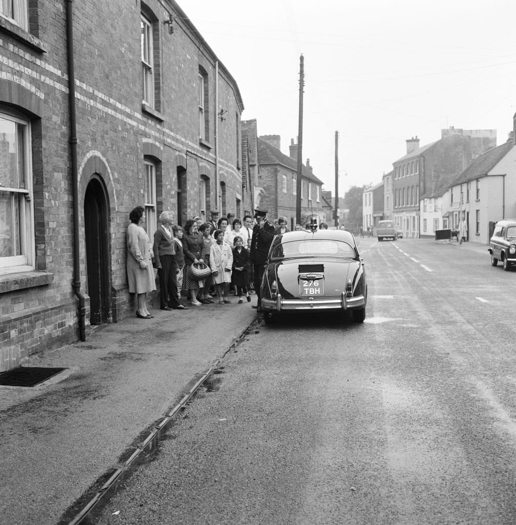 Police car equipped with a telephone loudspeaker unit, appeals for information in the village of Brill, Wednesday 14th August 1963.