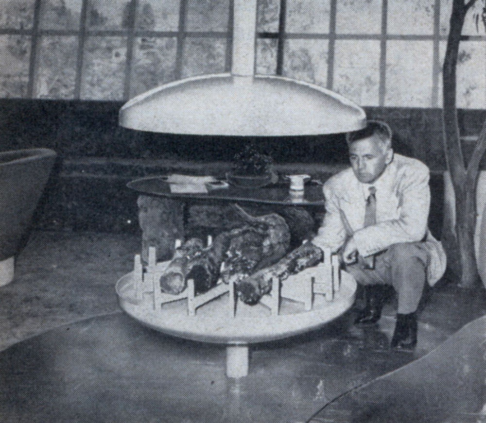 Smoke from midroom fireplace is caught by umbrella canopy, drawn up the chimney by fan mounted inside.