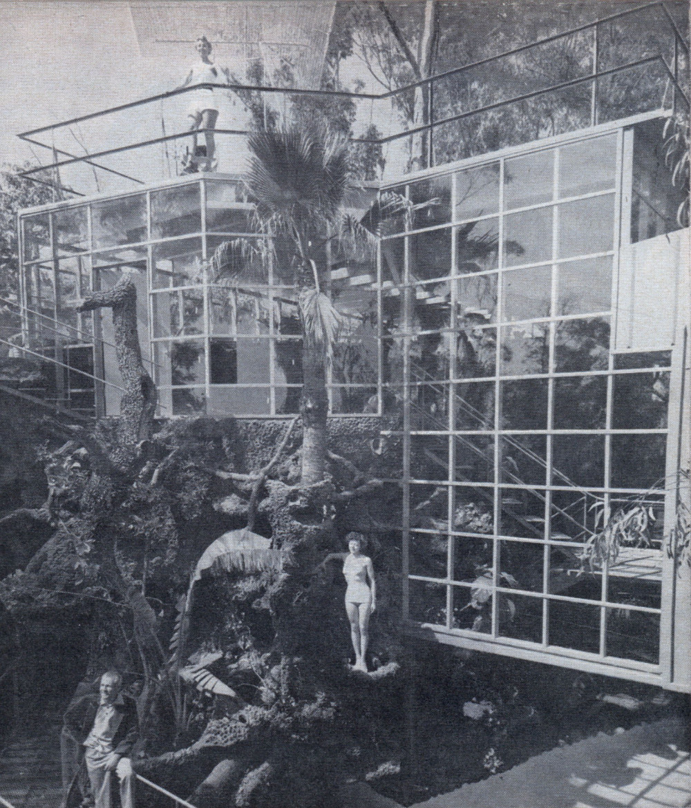 Main entrance of house is through tunnel visible at left. Glass walls at right protect an orchid grotto.