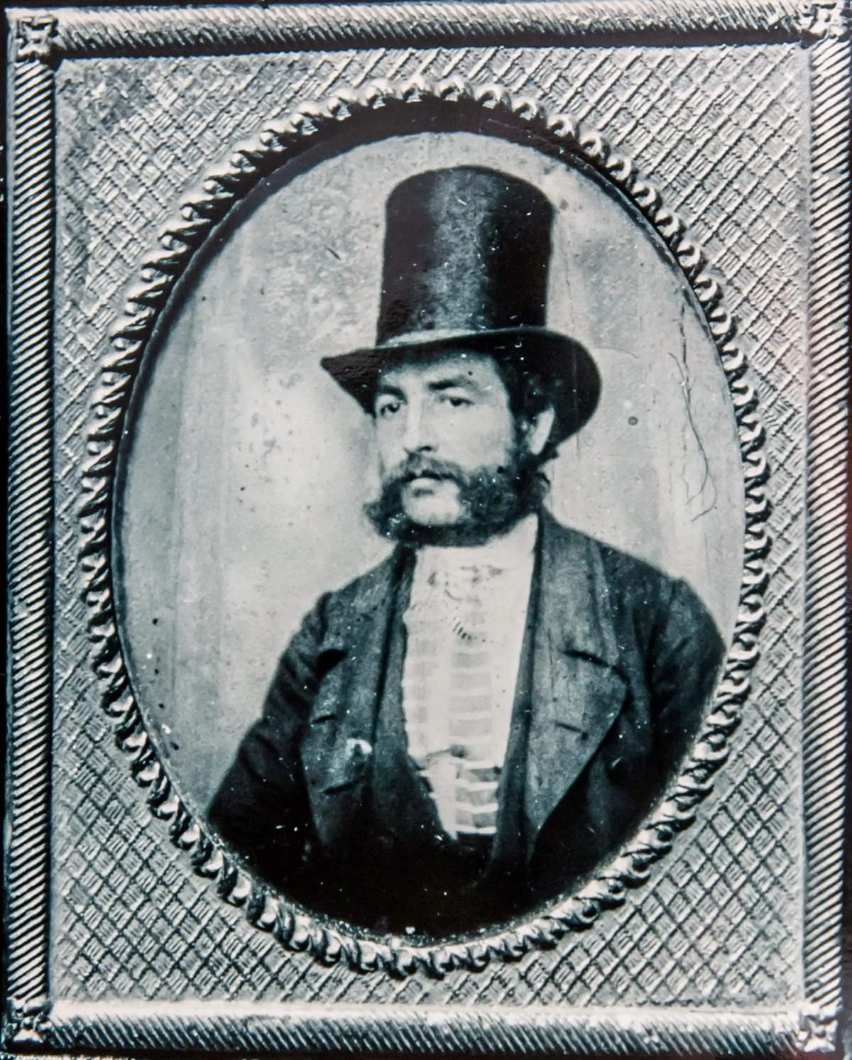 A mugshot of an unknown man in top hat.
