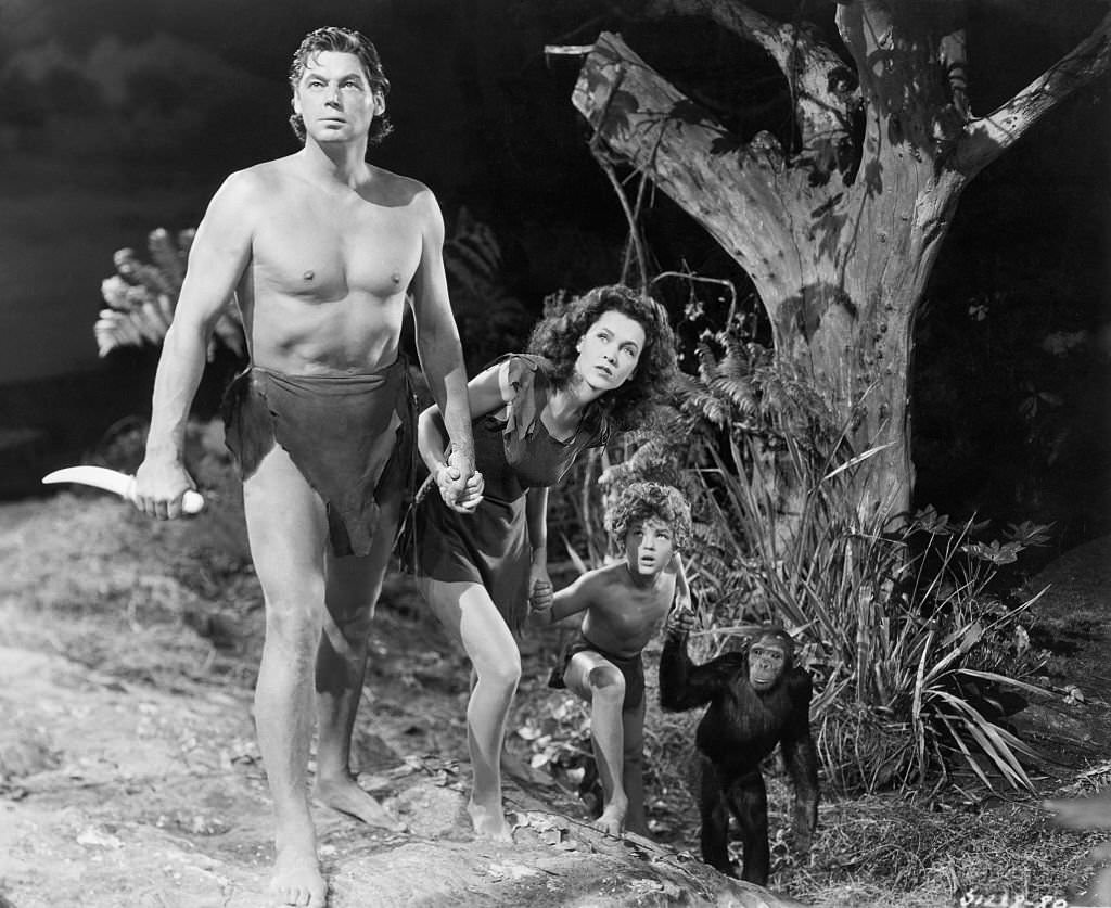 Johnny Weissmuller adn Maureen O'Sullivan, and kid (Johnny Sheffield), with chimp.