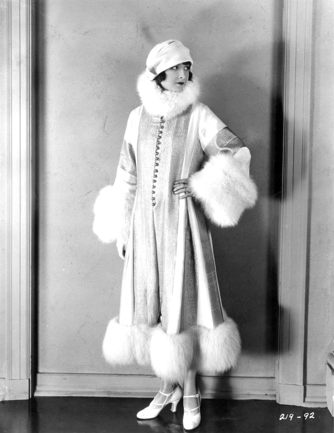 American actress Eleanor Boardman in cloche hat, wife of director King Vidor wearing a fur-trimmed outfit for her role in the silent film 'Proud Flesh', directed by Vidor for MGM, 1925