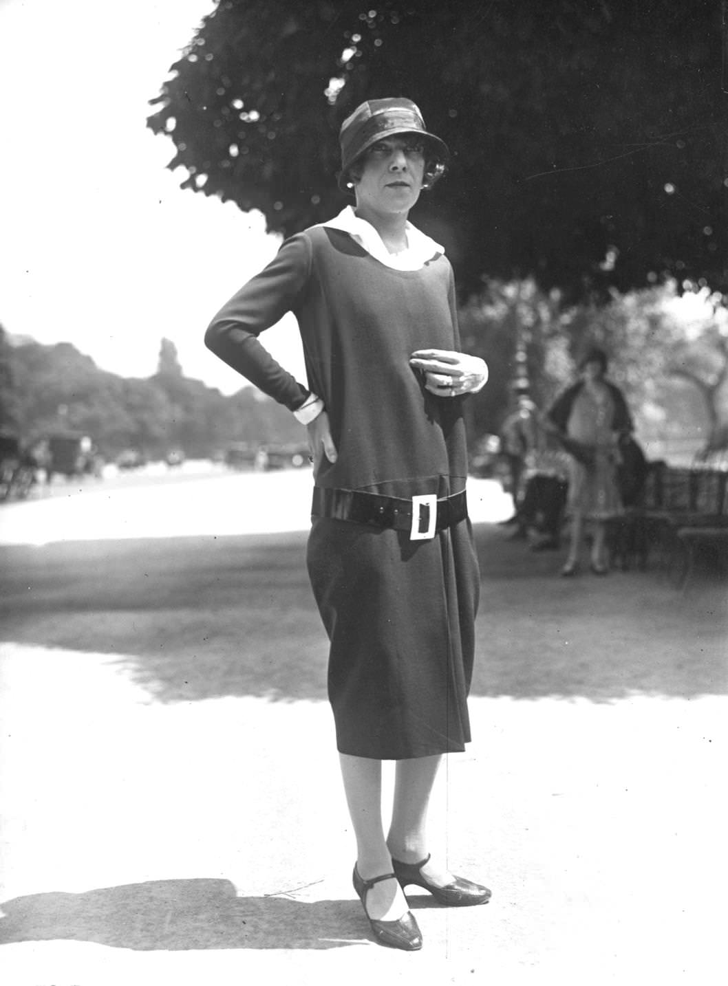 A Parisian woman wearing a dress with a low slung belt and cloche hat, 1925