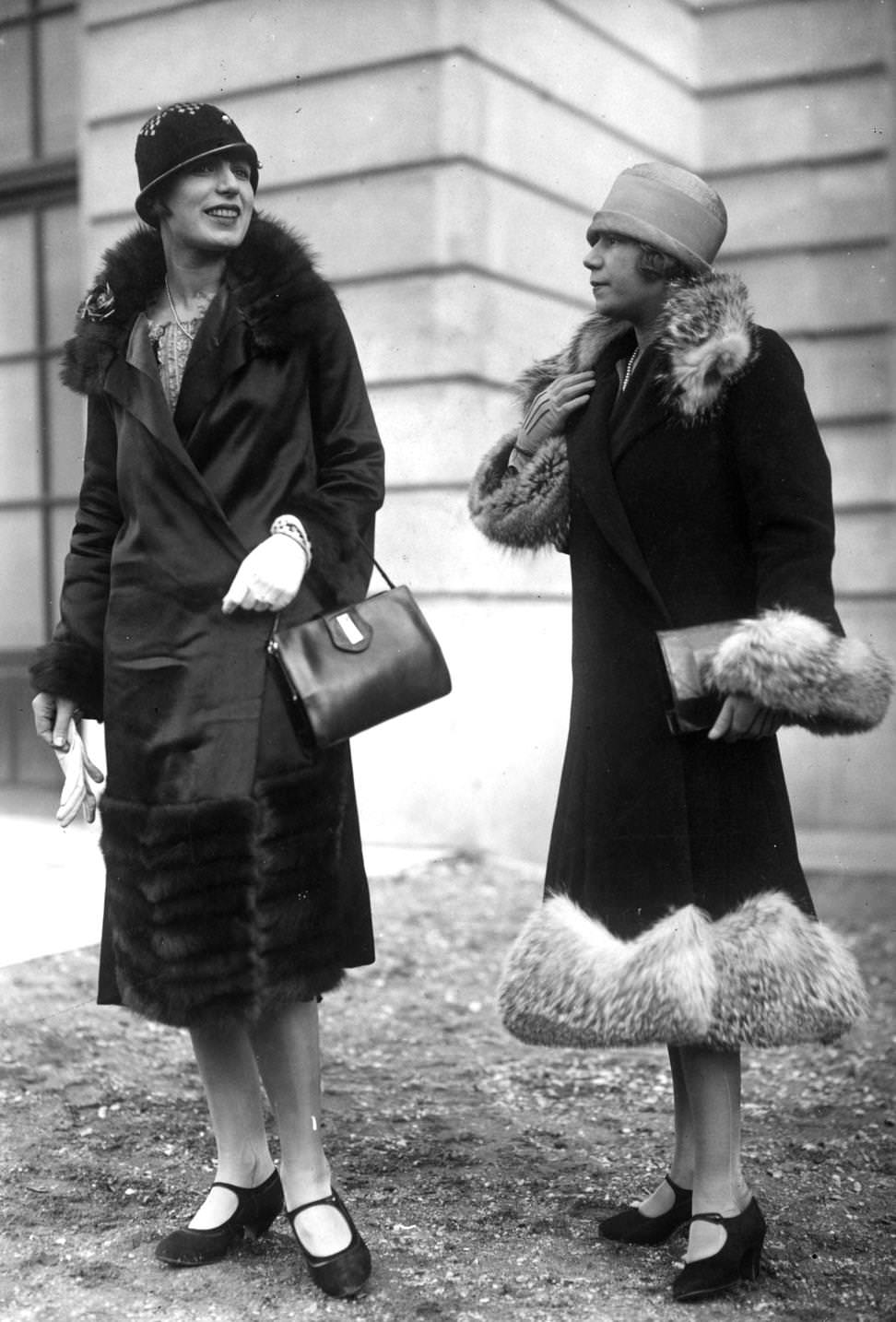 Fur trimmed wrap over coats designed by Heim, worn with cloche hats and one-bar court shoes, 1925