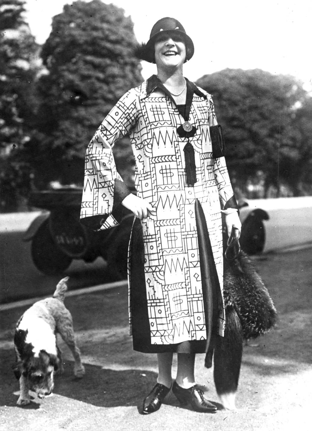 Bold geometric prints on this dress are relieved by panels of black around the cuffs, collar and skirt, 1925