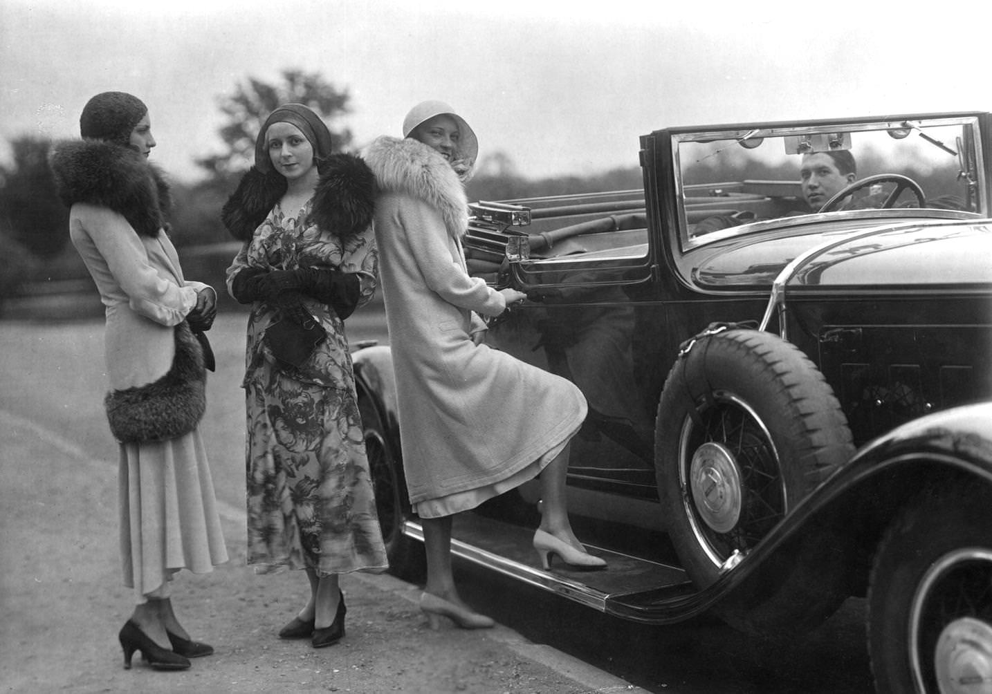 Models wearing coats and jackets with fur trim, and cloche hat, 1925