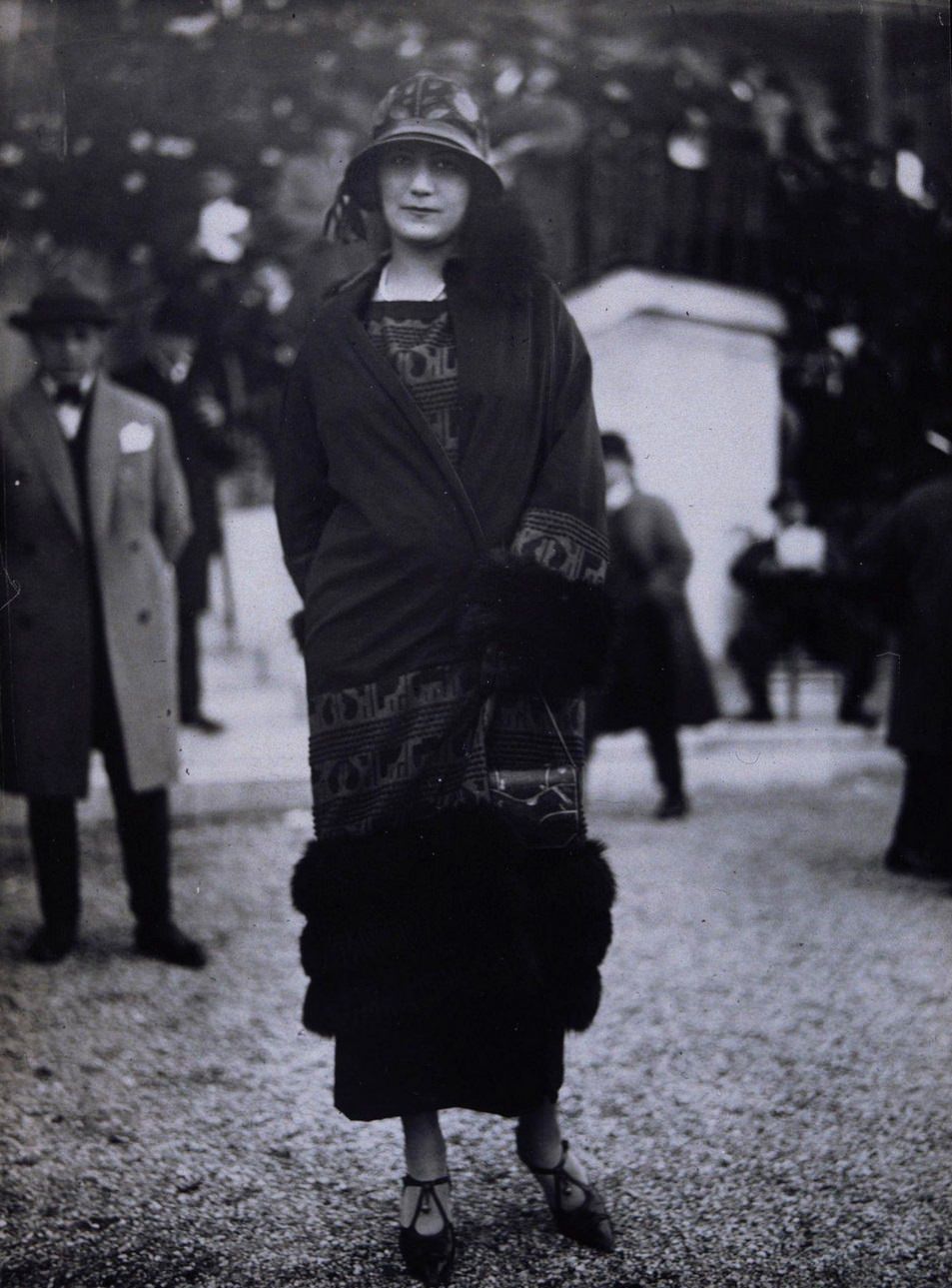 Fashion model wearing fur trimmed wrapover coat, Fashion model wearing a fur trimmed wrapover coat with matching dress, cloche hat and T-bar shoes, 1920,