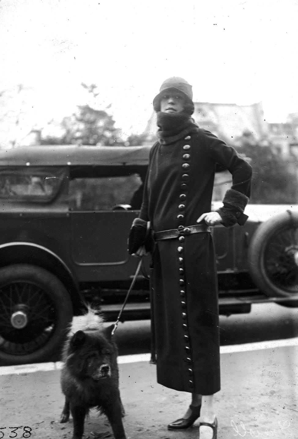 A Drecoll winter coat worn with a belt and with large buttons fastened from the neck to the hemline, 1920s