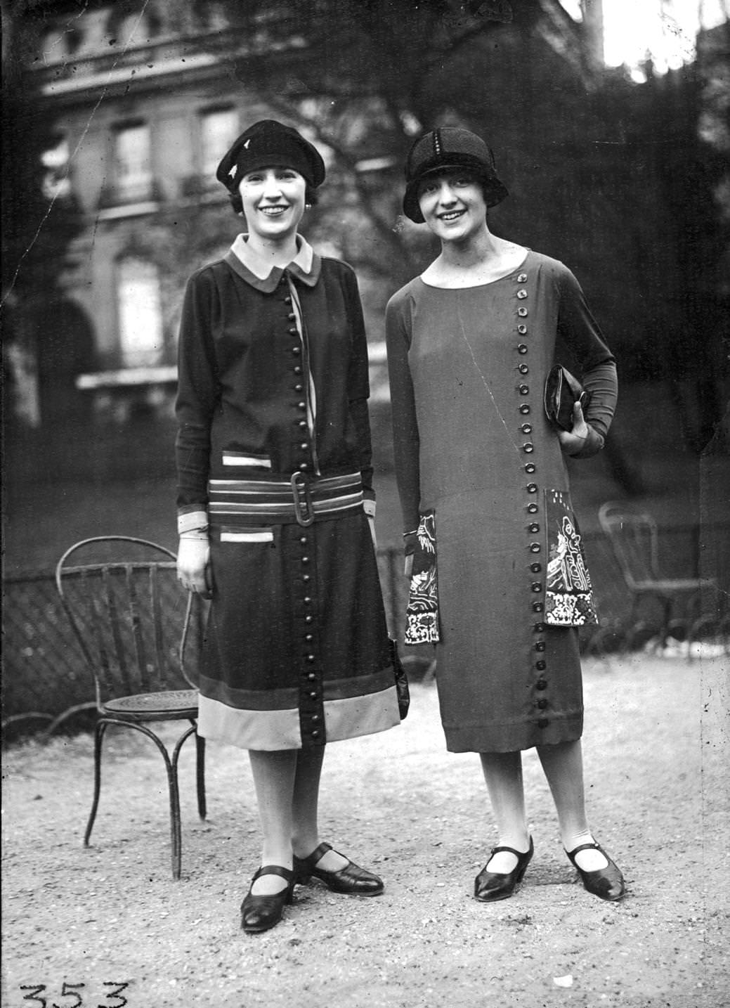 Walking frocks' decorated with thick sporty stripes and rich oriental patterns and fastened with buttons full-length and cloche hat, 1920s