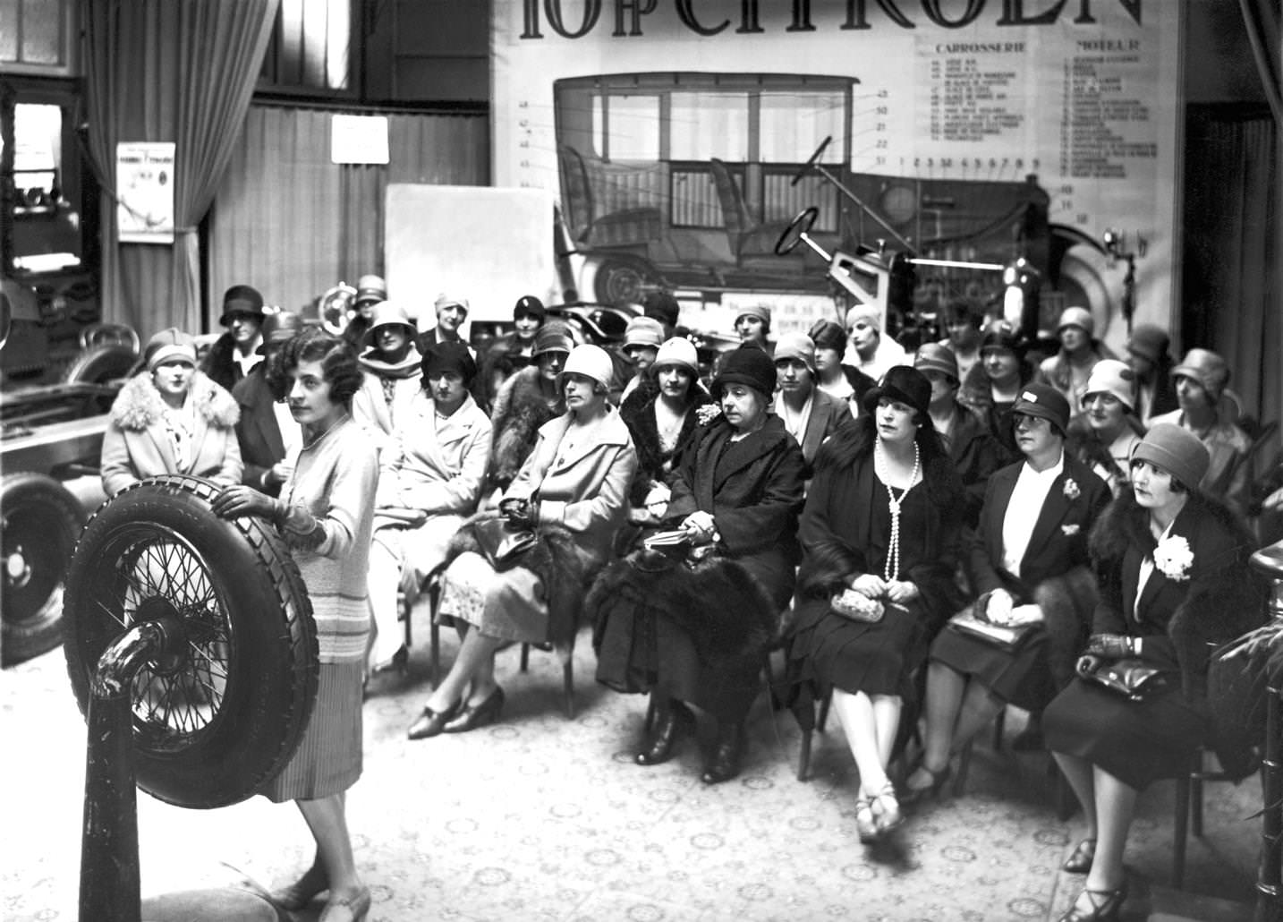 French women in cloche hats attend a car mechanics class run by Ms Versiguy, 1920s
