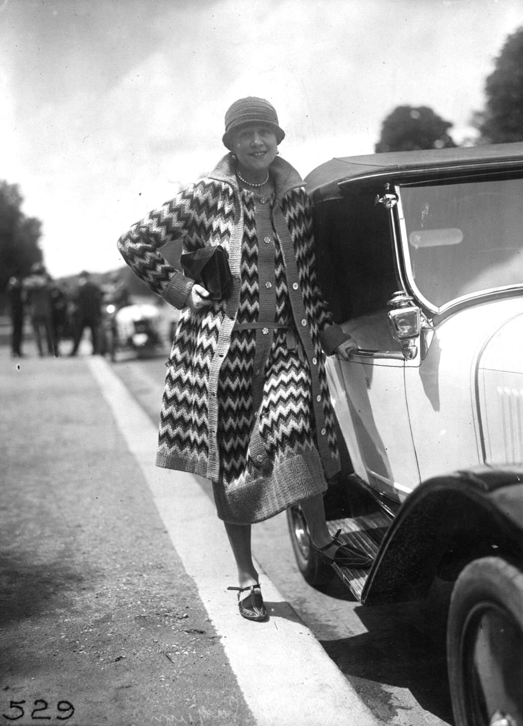 Fire-patterned knitted loose dress and seven-eights coat worn with a cloche hat, 1926