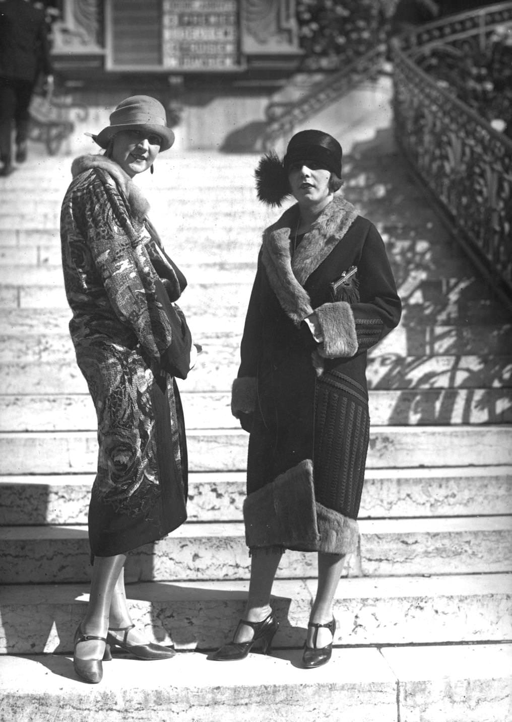 A model wearing a printed silk coat, with a model wearing a fur-lined coat and decorative hat, 1924