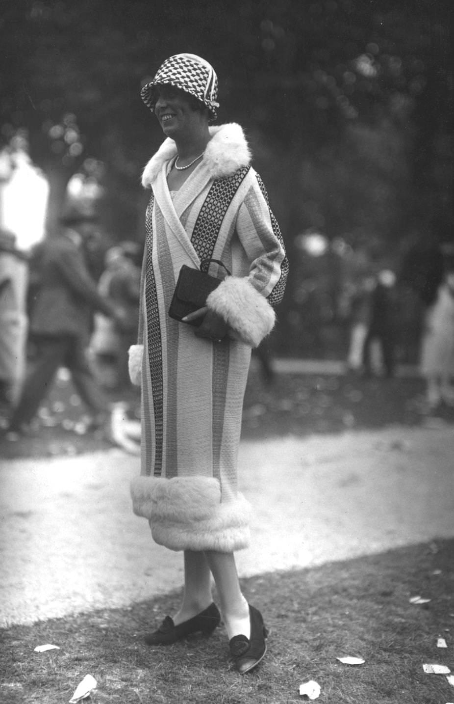 A stripy wraparound coat with fur trim, straight from the fashionable town of Deauville in northern France, 1925