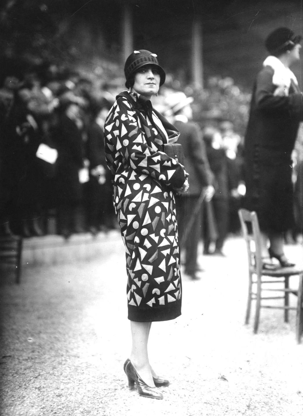 Patterned coat with black trim around the hem and cuffs, 1925