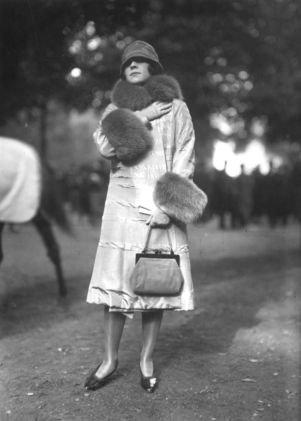 Quilted satin knee length coat with over-sized fur trim around the cuffs and collar, 1925