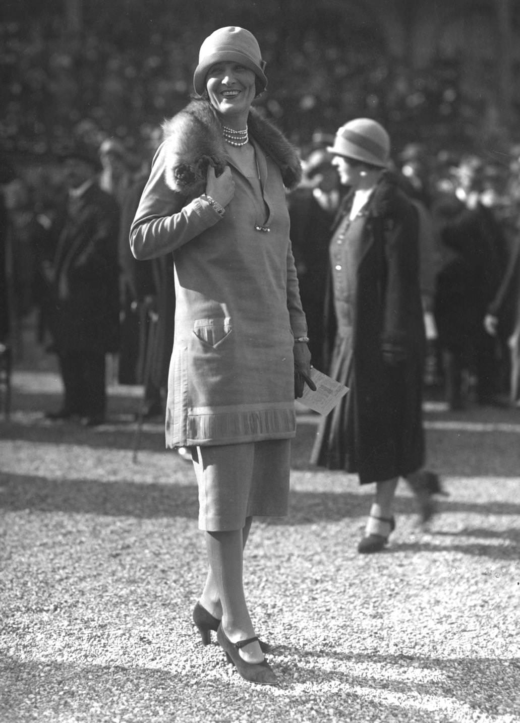 Matching skirt and tunic jacket, with a lace-trimmed collar, and cloche hats, designed by Paul Poiret, 1925