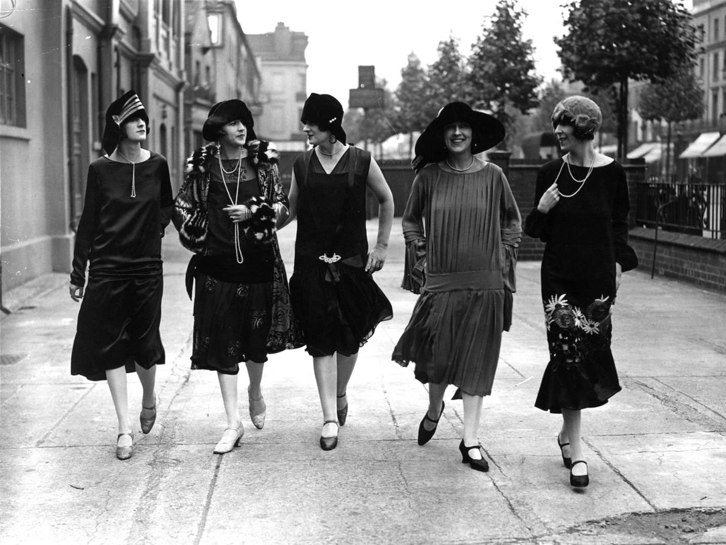 Models outside the fashion exhibition at Holland Park in London wearing comtemporary dropped waist dresses and styles of 25 years ago, 1925