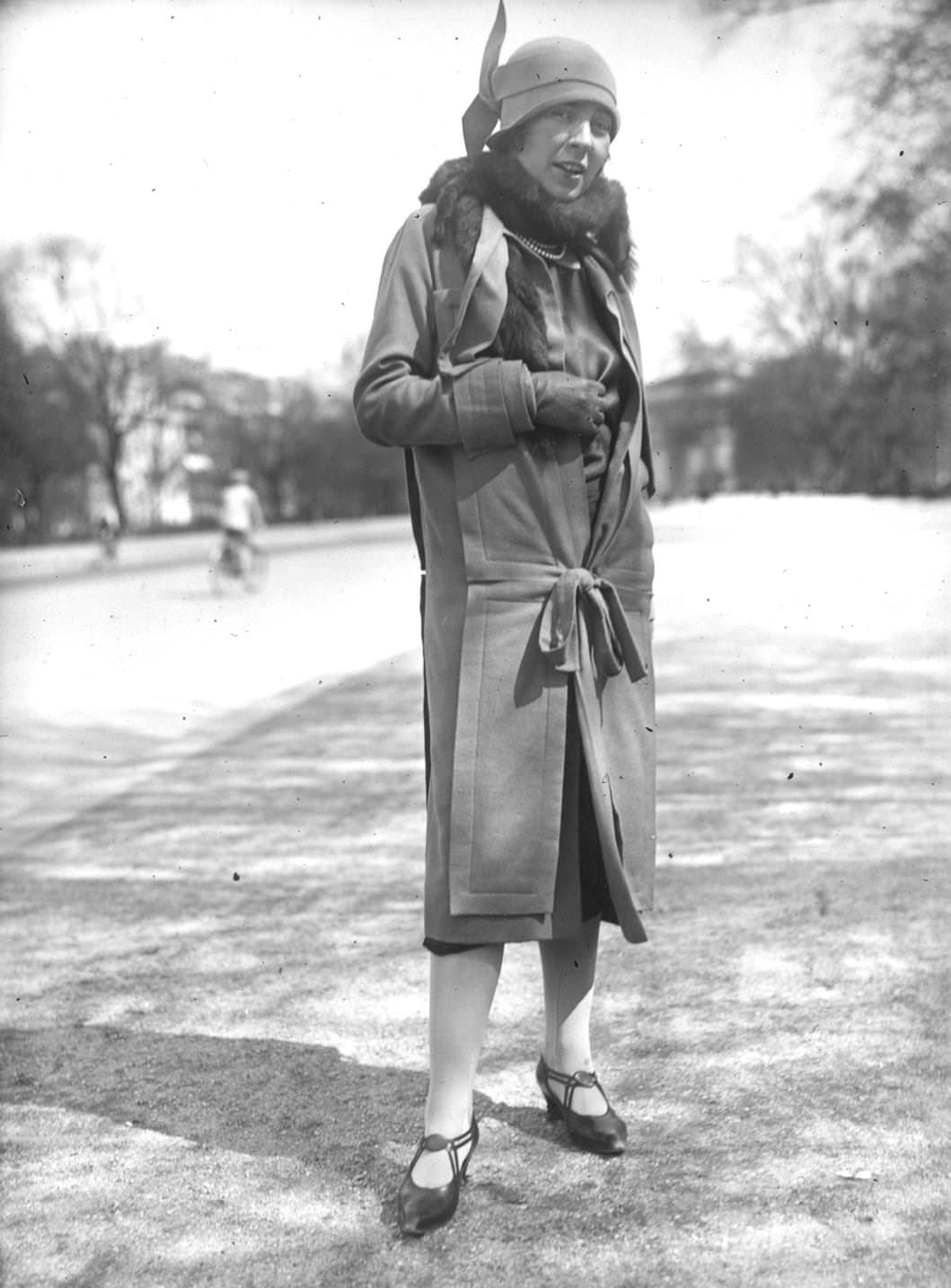 A woman wearing an innovative frock coat with a matching cloche hat, 1925
