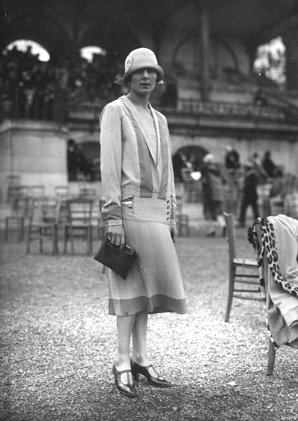 A model wearing a day dress with a design inspired by maritime clothing in a racing pavilion, 1925