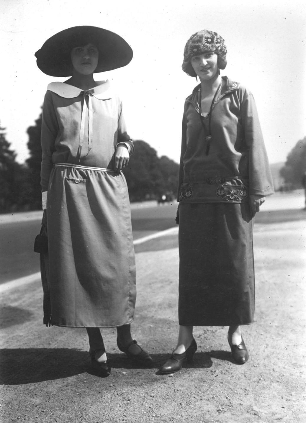 The woman on the right wears a variation of the classic sailor suit, with the waistline sitting on the hips, topped with a cloche hat, 1923