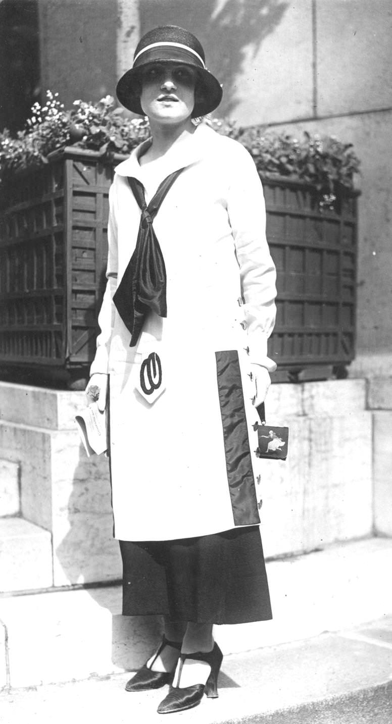 Low waisted, ankle length dress with black silk tie around the collar, 1923