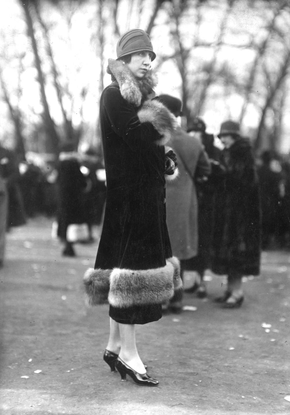 Velvet coat with fur trim around the cuffs, collar and hemline, and a felt cloche hat, illustrating the latest Parisian fashion, 1925