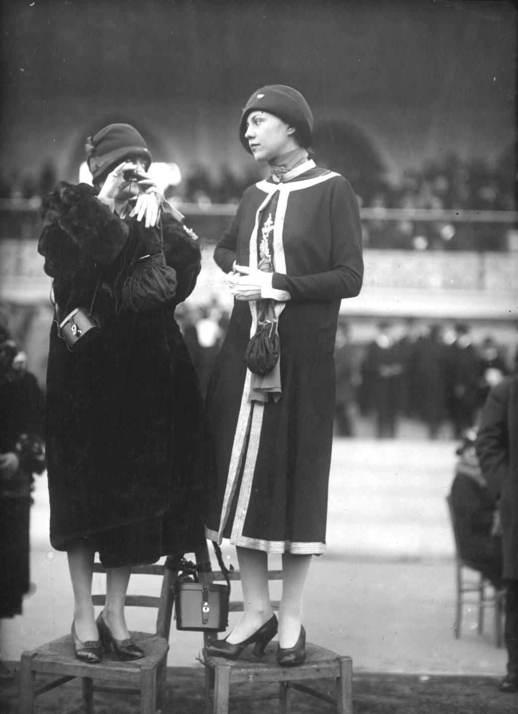 The latest fashions on public display, including fur coat and a knee length tunic coat with a single button at the neck, typical of the early 1920s.